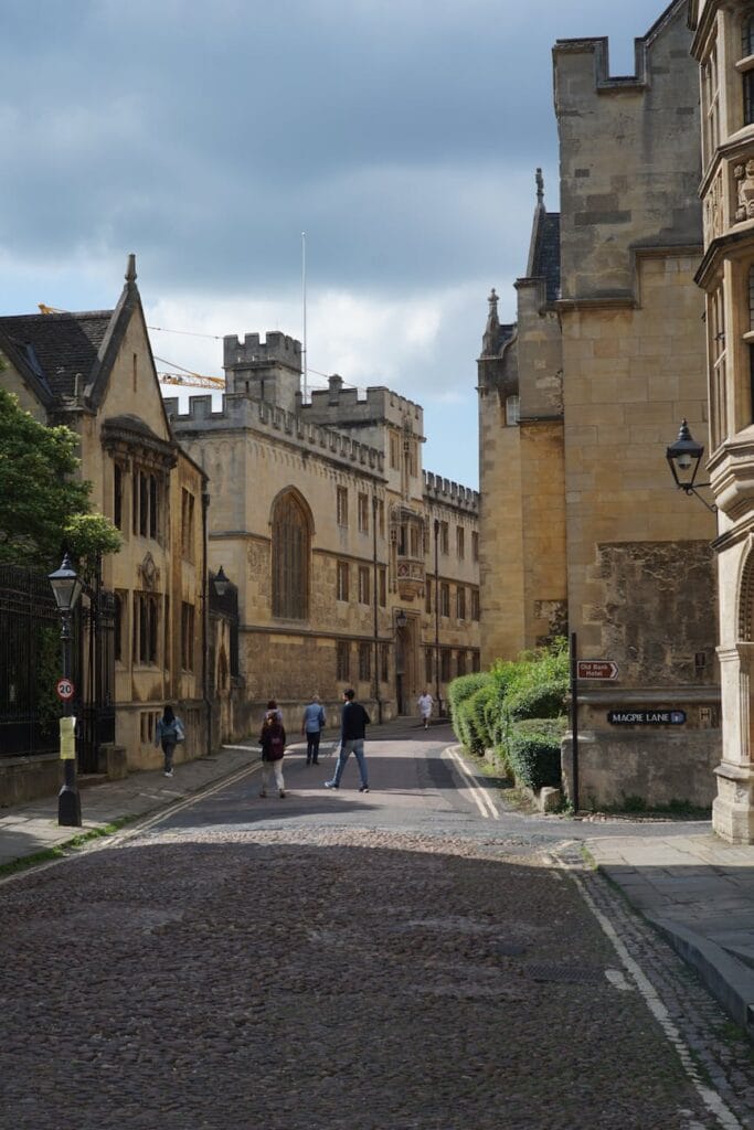 people walking near corpus christi college on merton street in oxford england