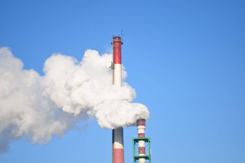 smoke stacks against blue sky