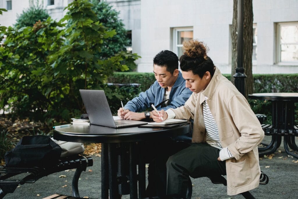 diligent multiethnic students doing homework together