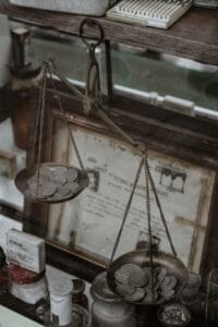 silver coins on an antique weighing scale