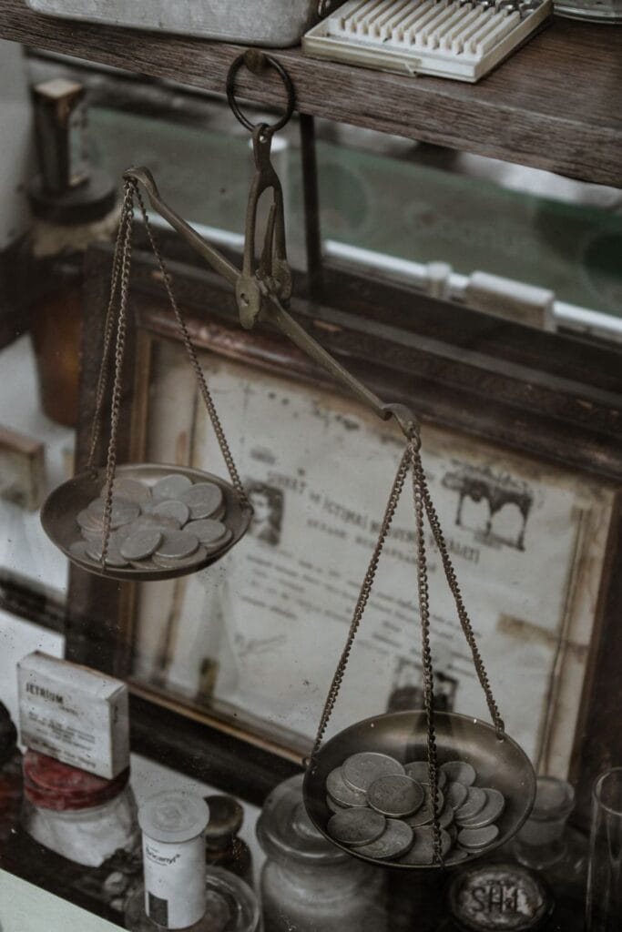 silver coins on an antique weighing scale